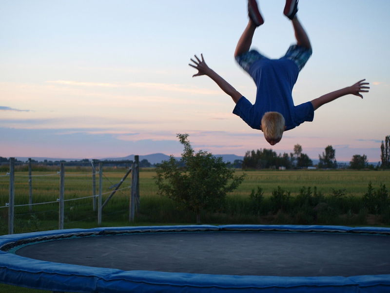 Jumping, Trick, motion, arms raised, fun, real people, excitement, mid-air, full length, swimming pool, bounce, tree, Salto, Trampoline, flying, leisure activity