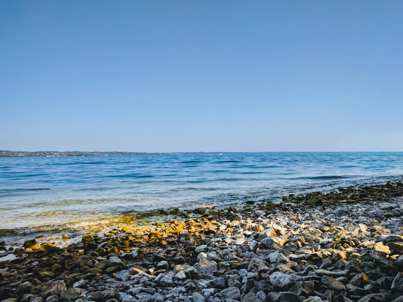solid, copy space, day, nature, rock - object, beach, blue, pebble, tranquility, clear sky, horizon over water, horizon, brown, land, rocky, water, 4K
