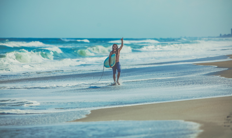 sky, male, bodyboard, horizon over water, adult, nature, human arm, walking, outdoors, beach, coast, sea, vacations, arms raised, people, swimwear, alone