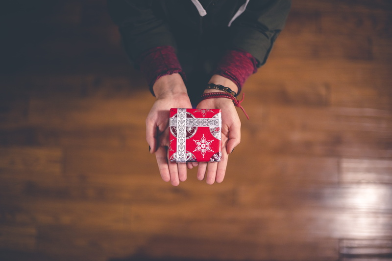 red, lifestyles, wrapped, arms, midsection, human limb, women, person, limb, human Hand, white, adult, finger, ribbon, wood - Material, table, people, gift