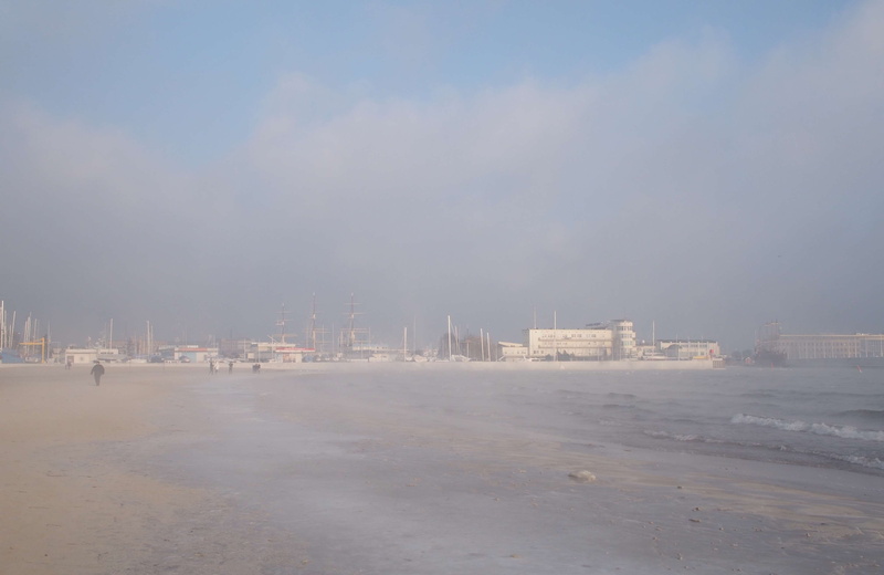 outdoors, office building exterior, sky, cold, pollution, building exterior, cityscape, snow, water, beach, cold temperature, built structure, sea, fog