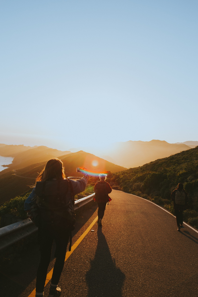 sky, road, walking, men, sunrise, outdoors, asphalt, lifestyles, non-urban scene, light, group, environment, rear view, real people, near, blue, nature