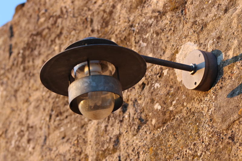 lamp, built structure, rock - object, masonry, outdoors, wall, shape, close-up, light, lantern, day, metal, 2K, outdoor lighting, sunlight, no people