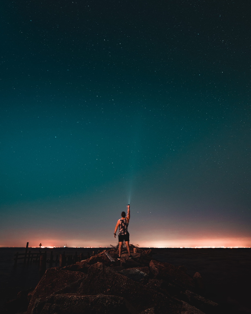 milky way, lifestyles, light, space, star, fairhope yacht club, looking up, turned, ocean, holding, star - space, full length, tree, bay, flash light, leisure activity