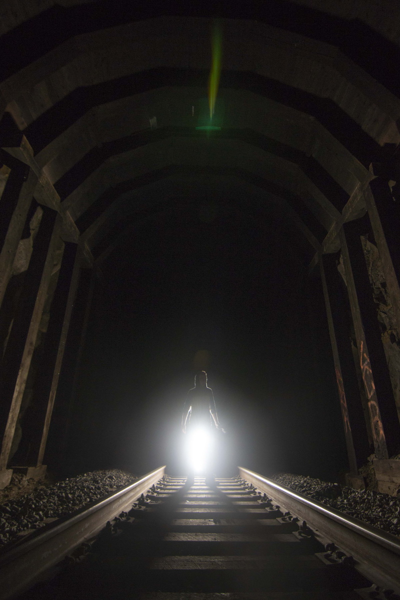 illuminated, the way forward, indoors, ambient, built structure, tracks, light, united states, real people, long exposure, tunnel, lighting equipment, lifestyles