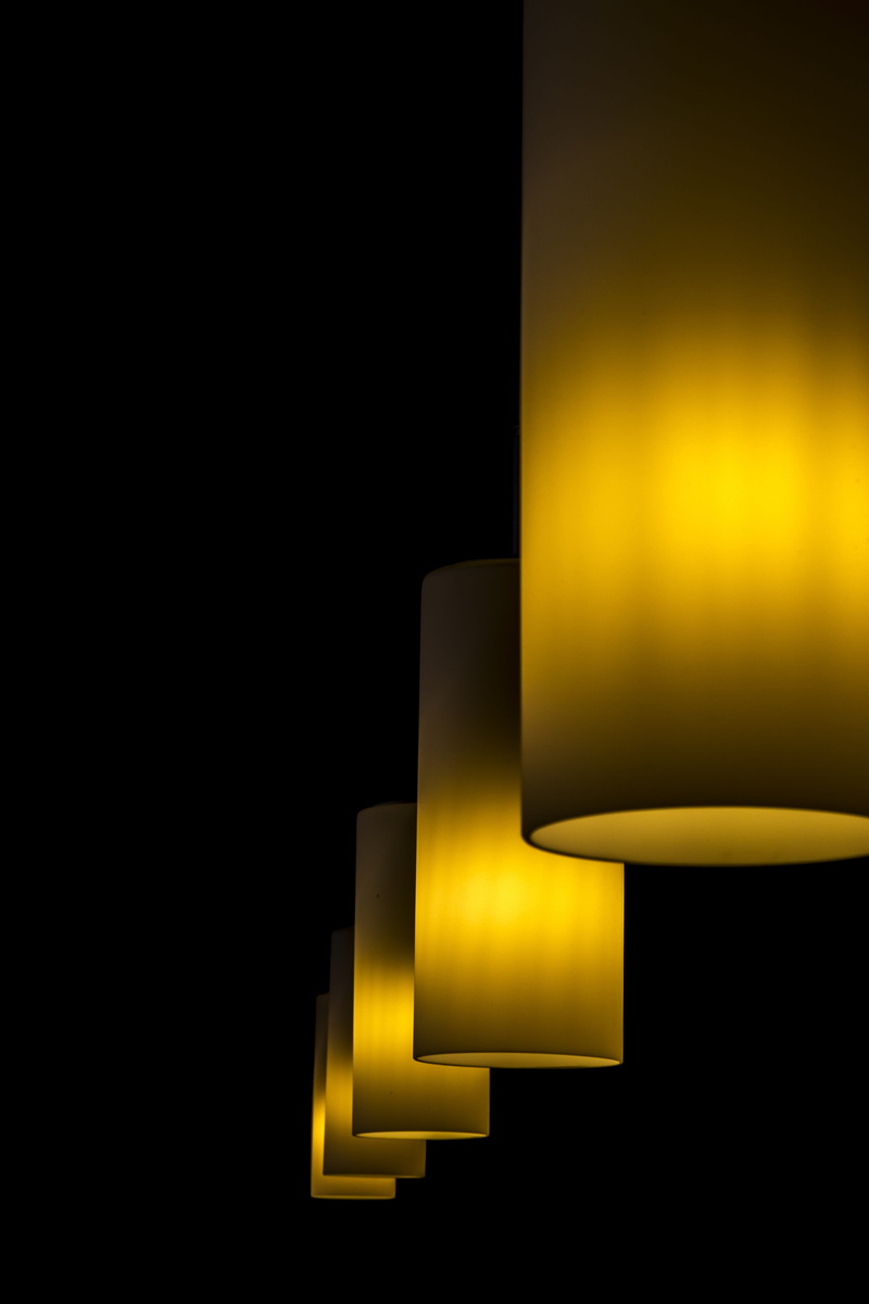 copy space, indoors, electric light, black background, voltage, illuminated, hanging, light, yellow, ambient, light - natural phenomenon, design, close-up