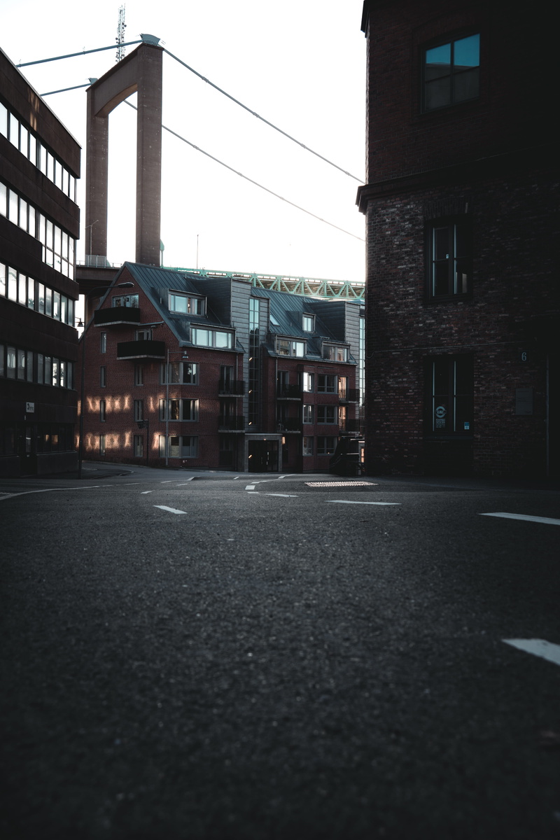 sony, built structure, sky, sun, building, ambient, sunny, no people, road, marking, surface level, outdoors, street, the way forward, building exterior