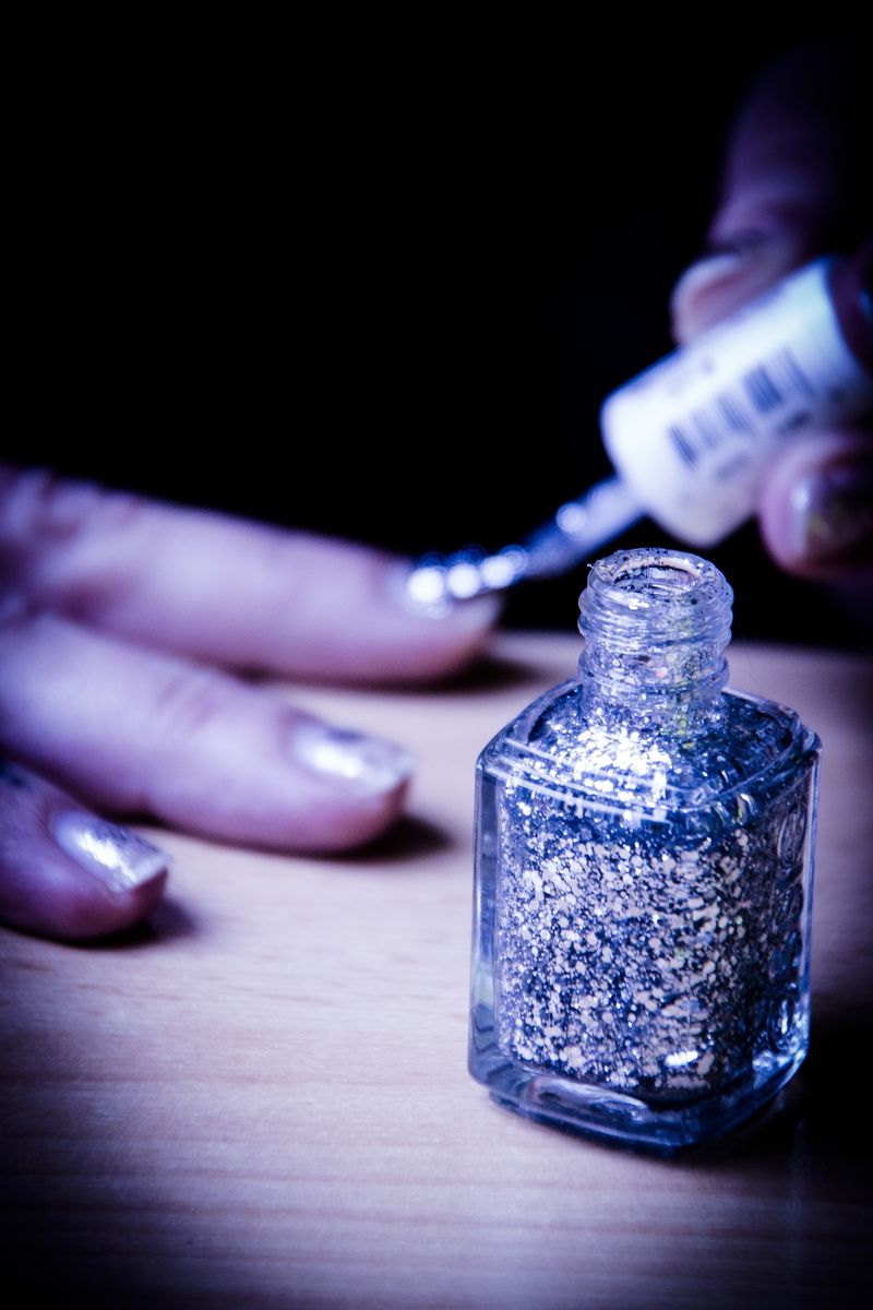 table, body part, holding, hand, fashionable, fingernails, 5K, adult, selective focus, nail art, human body part, bottle, paint, pedicure, manicure, real people