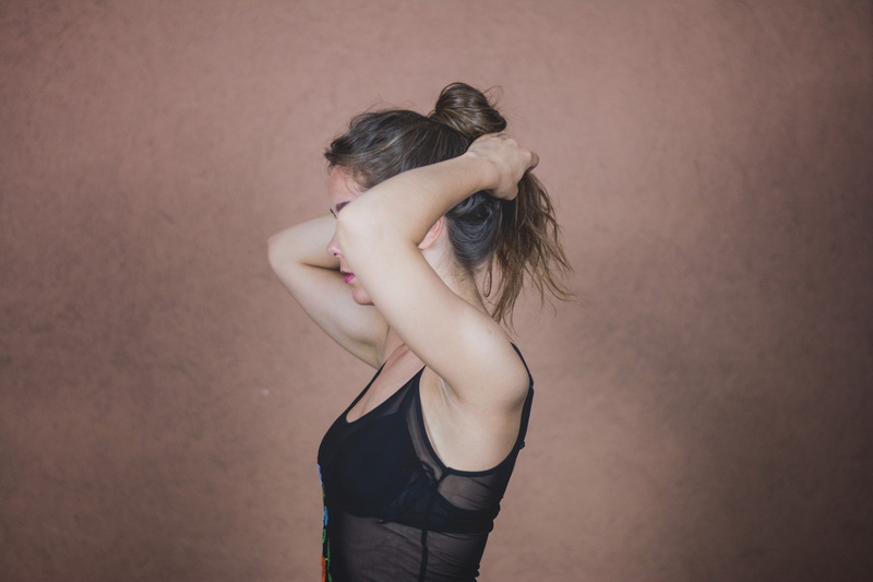 standing, black shirt, wall, people, one woman only, color Image, facing, brown hair, hairstyle, caucasian Ethnicity, studio shot, beauty, hair, human arm