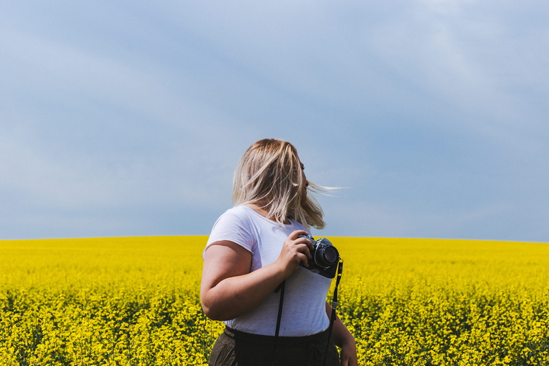 bridge, photo, agriculture, flower, land, long hair, outdoors, manual, women, lady, woman, yellow, flowering plant, caucasian, camera, field, one person