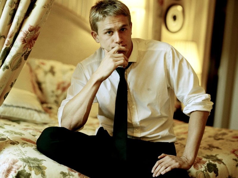 s, sadness, sitting, real people, front view, looking, one Man Only, three quarter length, looking At Camera, holding, business, dress, charlie hunnam