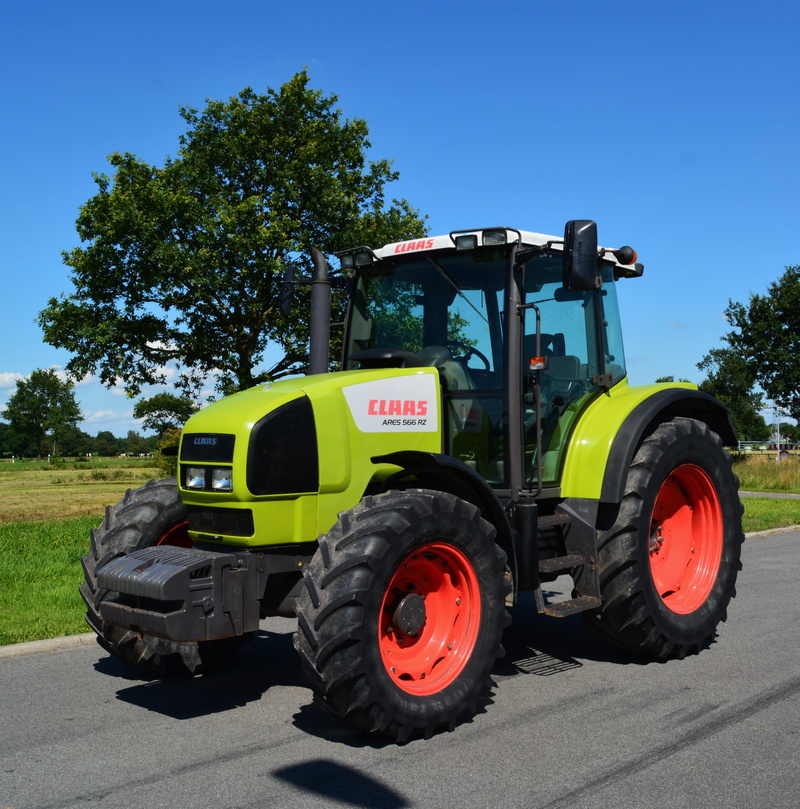 no people, plant, machine, tractor, day, land vehicle, tree, transportation, truck, machinery, sky, mode of transportation, clear sky, outdoors, city, agricultural machinery