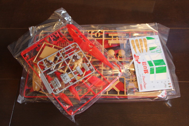 hayao miyazaki, box, plane, assembly, container, large group of objects, high angle view, porco rosso, bag, 5K, cartoon, plastic, animation, text, childrens