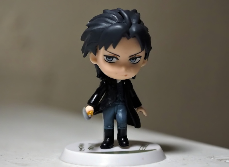 male likeness, bleach, cartoon, toy, table, male, art and craft, tv, black color, close-up, food and drink, human representation, sweet food, representation