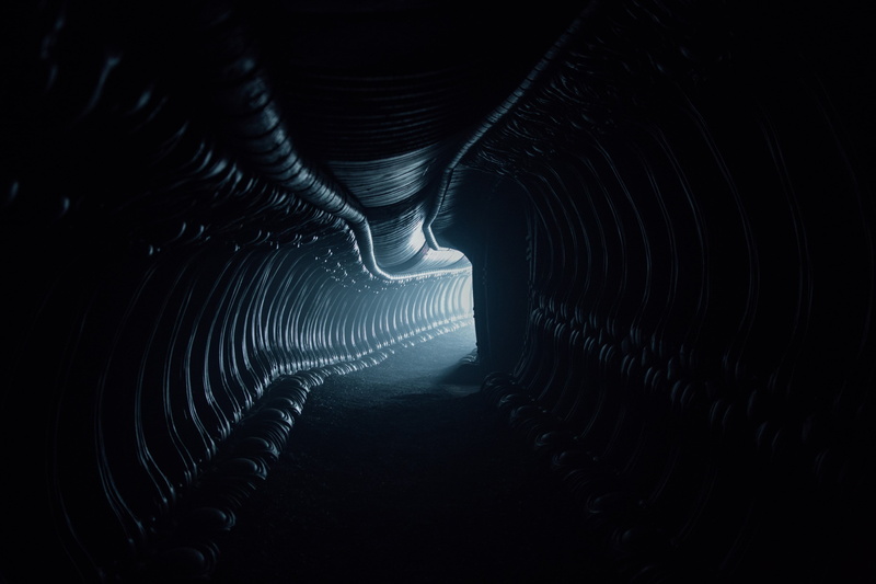 direction, transportation, concentric, motion, black background, illuminated, architecture, indoors, no people, dark, road, built structure, light at the end of the tunnel