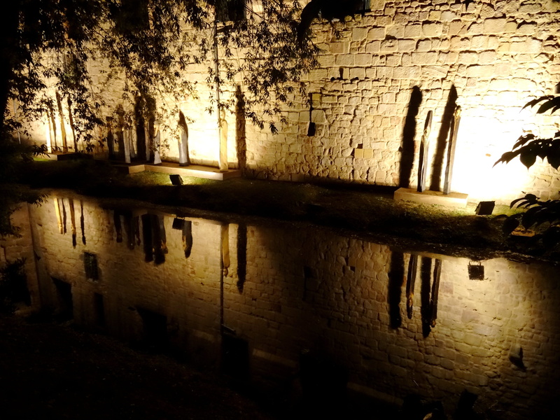 figures, outdoors, waterfront, textured, night, light, wall - building feature, no people, reflection, castle, mirroring, lighting, wall, architecture