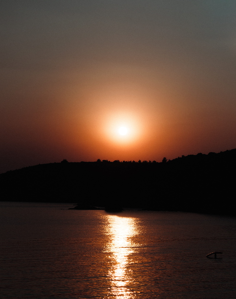 sun, waterfront, sunset, outdoors, stock, calm, beauty in nature, vacation, idyllic, silhouette, trees, reflection, sea, tranquility, scenics - nature