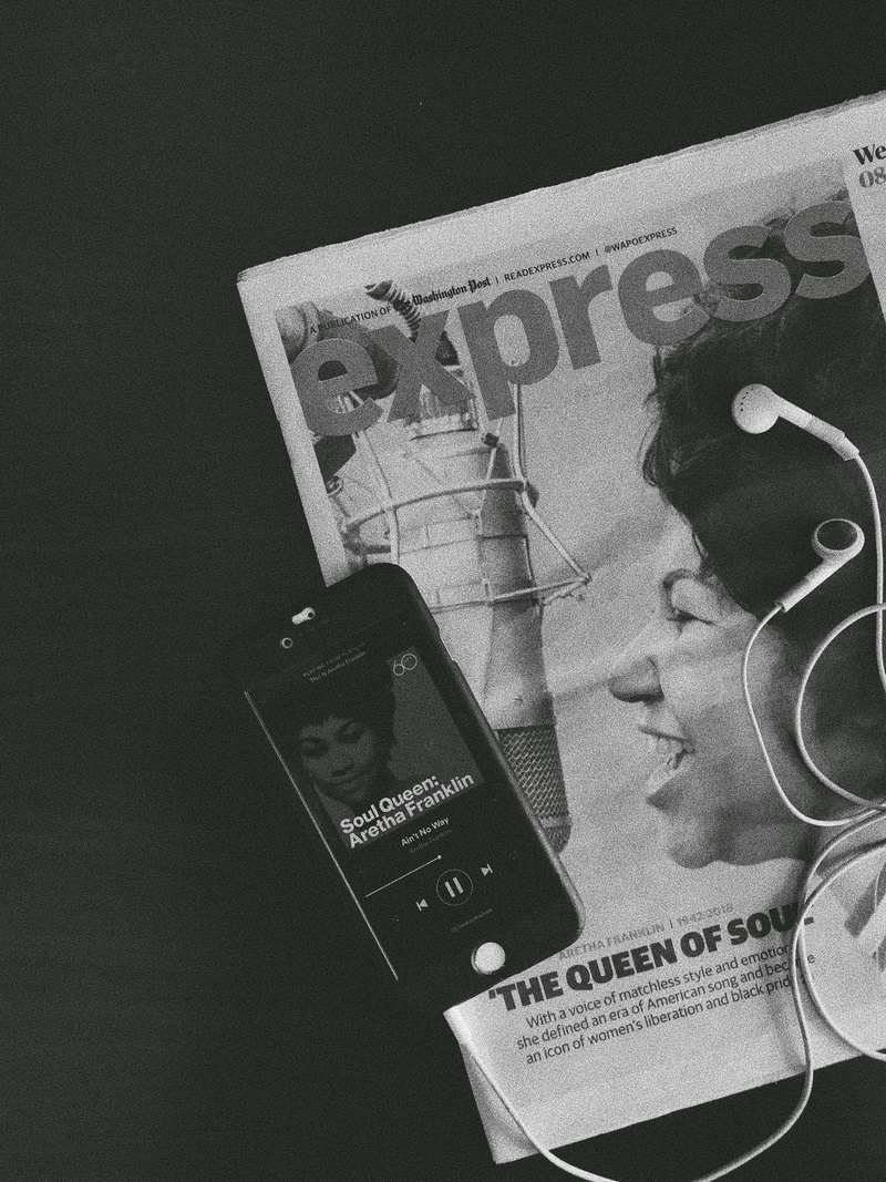 newspaper, music, western script, aretha, studio shot, time, aretha franklin, soul music, representation, holding, human representation, high angle view