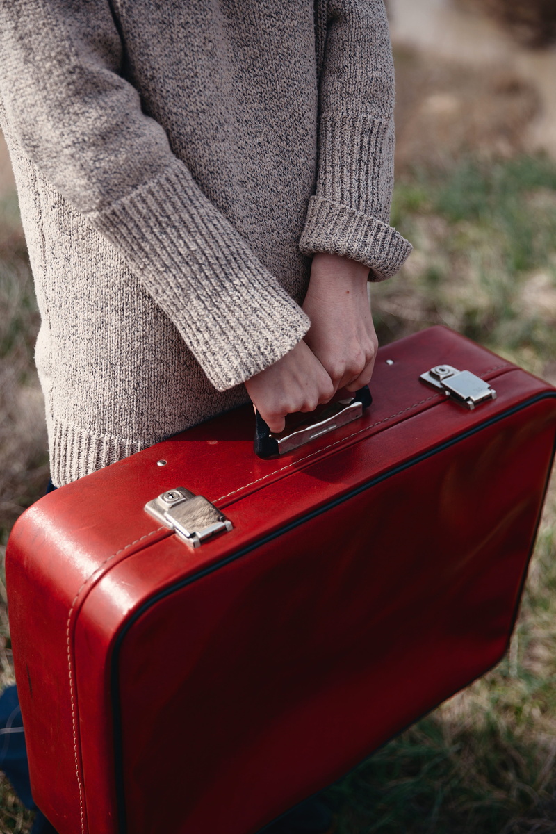 hand, sweater, focus on foreground, people, tourist, luggage, midsection, day, adventure, clothing, retro, warm clothing, red, human body part, technology