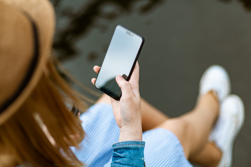 technology, portable information device, smartphone, day, connection, hat, message, screen, adult, sitting, hold, one person, text messaging, style, modern