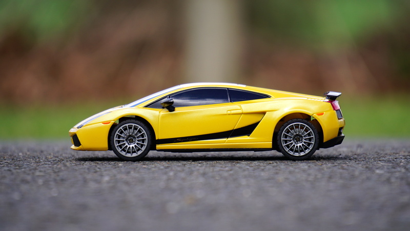 motor, yellow taxi, auto, street, surface level, daytime, technology, cast, toy, single object, wheel, close-up, asphalt, automotive, expensive, style