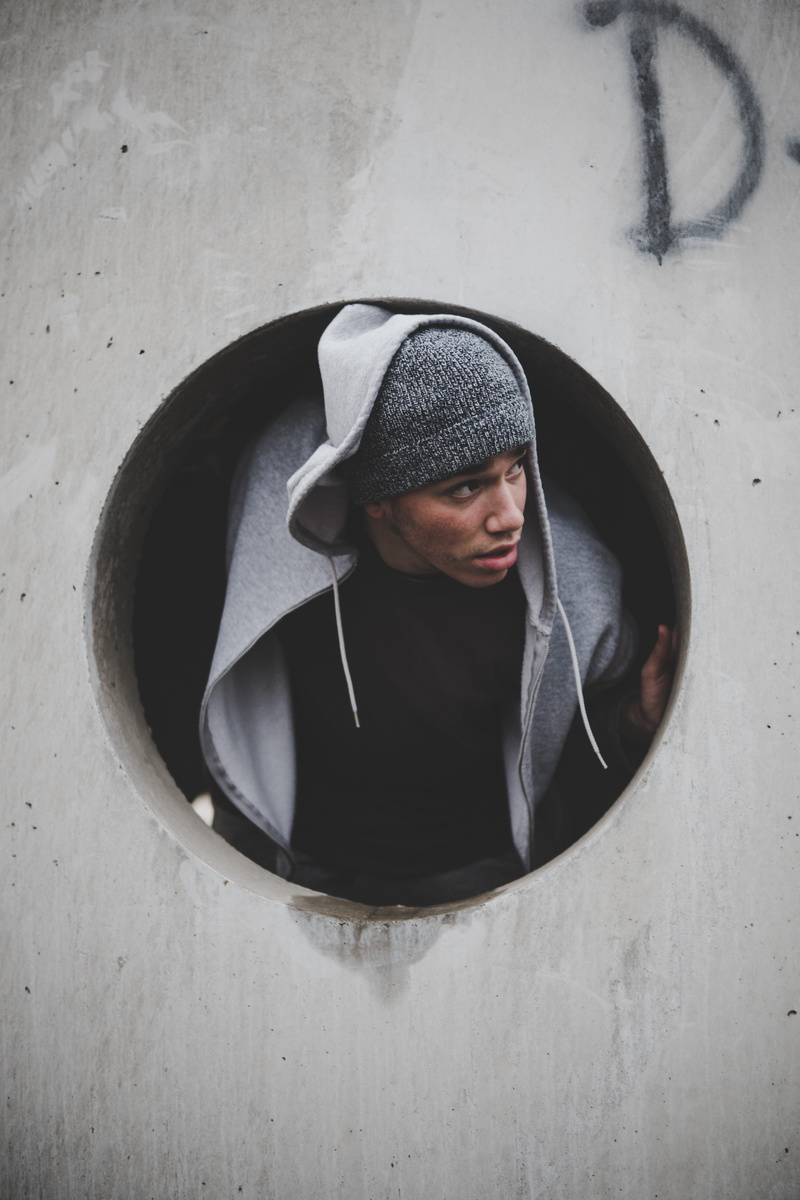 circle, coming, hood, young adult, shape, model, real people, indoors, standing, young men, geometric shape, concrete, architecture, portrait, jacket, day
