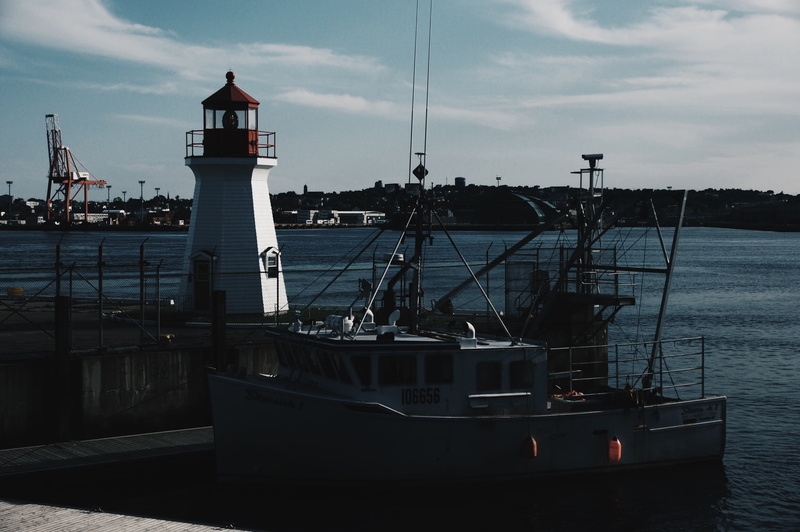 nautical vessel, tower, mode of transportation, sky, architecture, nature, harbor, pier, sailboat, lighthouse, transportation, guidance, construction site