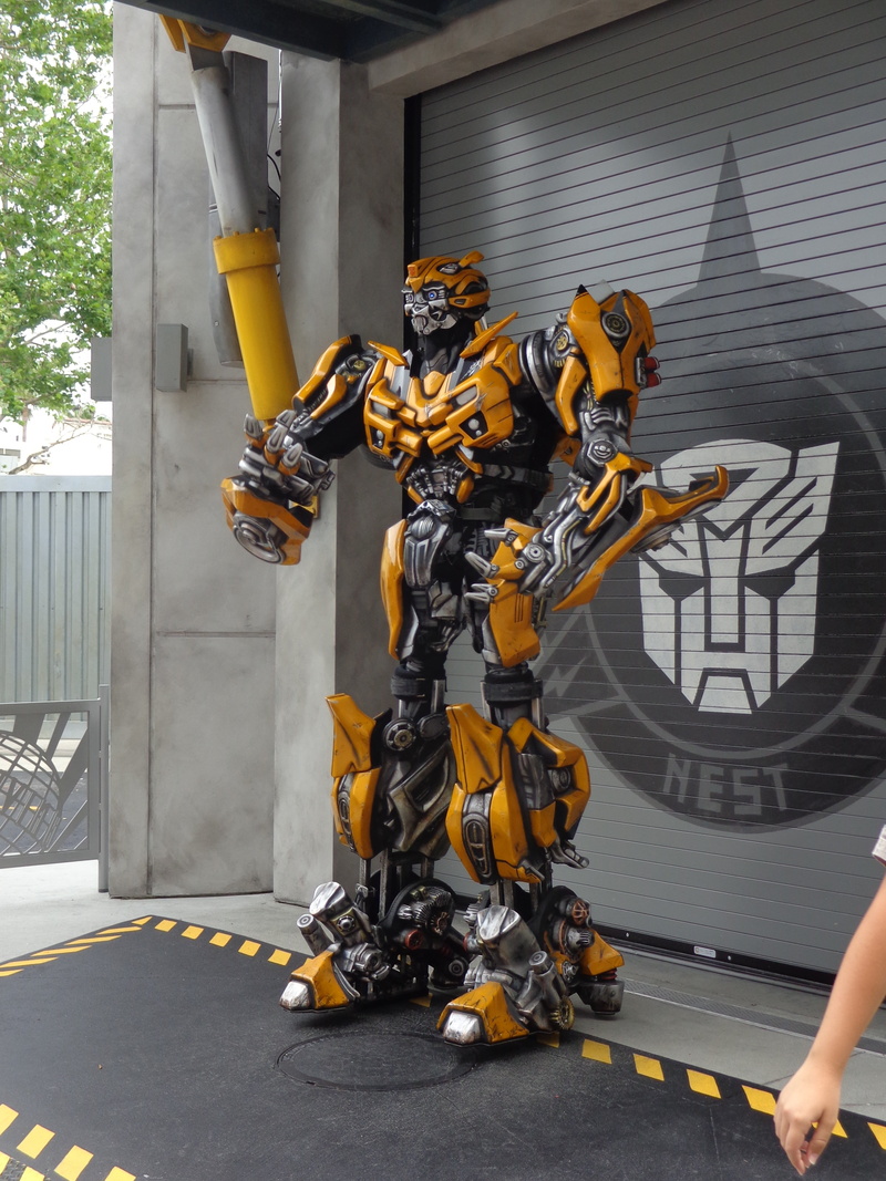 built structure, outdoors, art and craft, robot, male likeness, creativity, cyborg, futuristic, gray, front, day, human body part, city, human representation