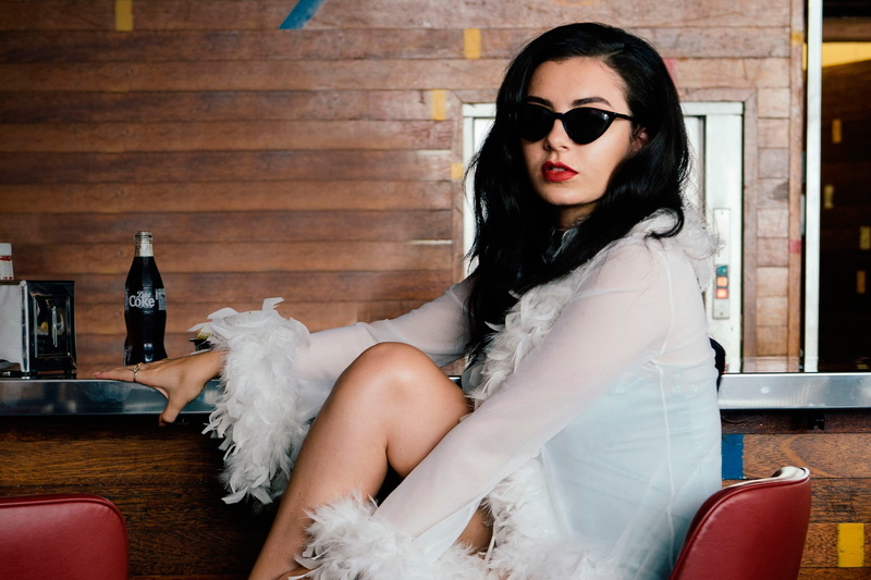 indoors, glasses, sitting, young adult, hairstyle, adult, one person, Charli XCX, 1080P, hair, real people, beauty, singer, white, s, beautiful woman