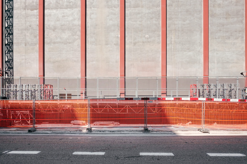 road marking, urban, boundary, security, near, road, outdoors, building Exterior, railings, no people, construction, cone, gray, city, safety, built structure