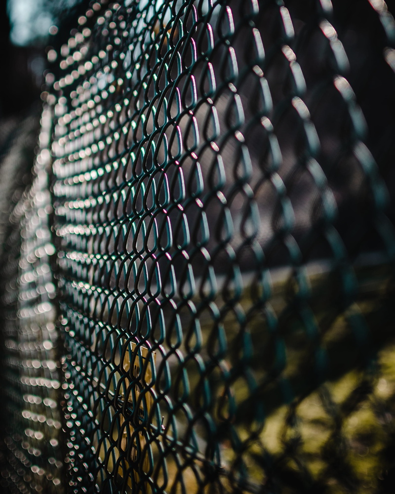 no people, neck, electronics, wire, wire mesh, repetition, harness, textured, prison, safety, furniture, selective focus, crystal, fire screen, focus on foreground