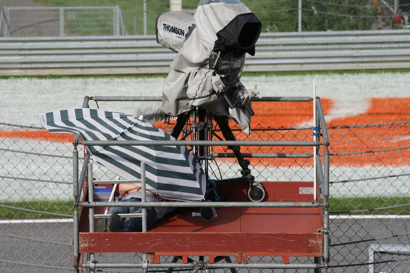 media, cinematographer, camera, film camera, car racing, turn, nature, barrier, film team, watch tv, director, metal, bench, focus on foreground, sport