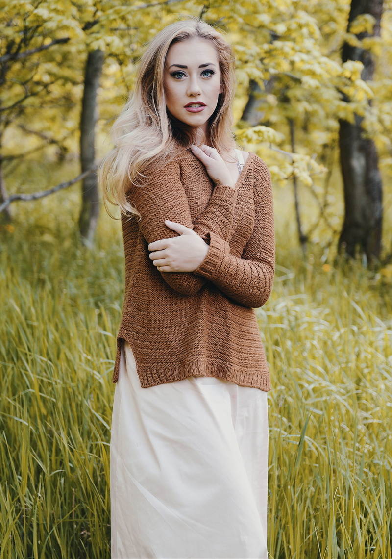 cardigan, woman, hiking, buckle, grass, wearing, plant, green, hoodie, person, outdoors, beautiful woman, hair, one person, long sleeve, beauty, looking at camera