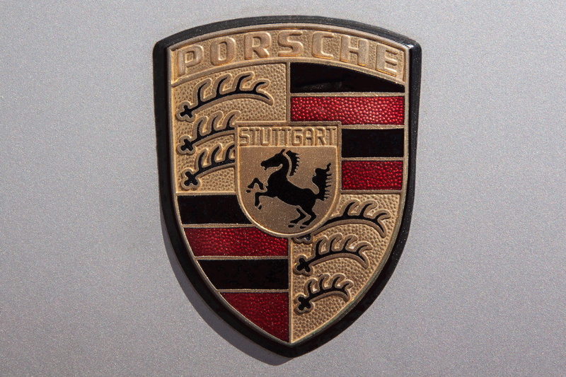 animal representation, no people, brand, sports car, porsche, carving - craft product, coat of arms, shape, part of the volkswagen group, luxury, gray