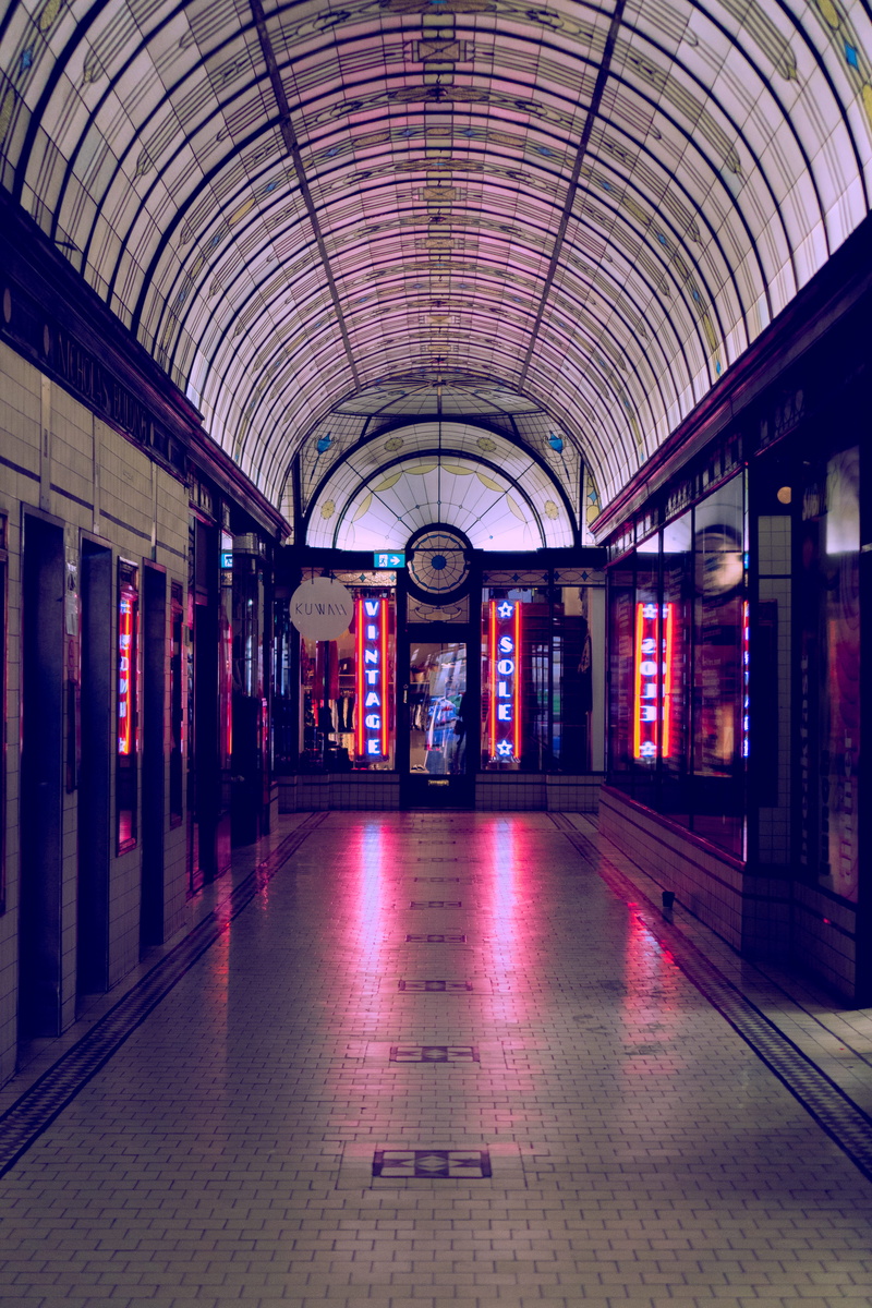 banister, no people, tile, art gallery, clock tower, tiled floor, arcade game machine, direction, rail transportation, handrail, arch, built structure