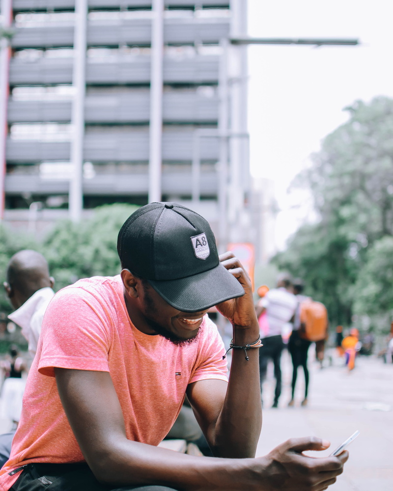 photoshoot, blur, boy, model, sitting, wear, incidental people, day, real people, guy, communication, laughing, male, one person, texting, style, cellphone