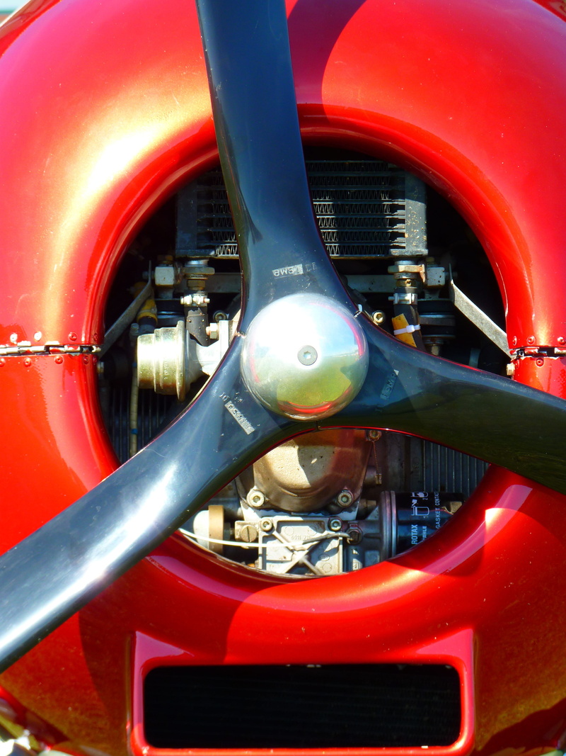 rotation, retro styled, red, aircraft, transportation, silver colored, outdoors, machinery, wheel, motor vehicle, paintwork, travel, no people, motor, steering wheel