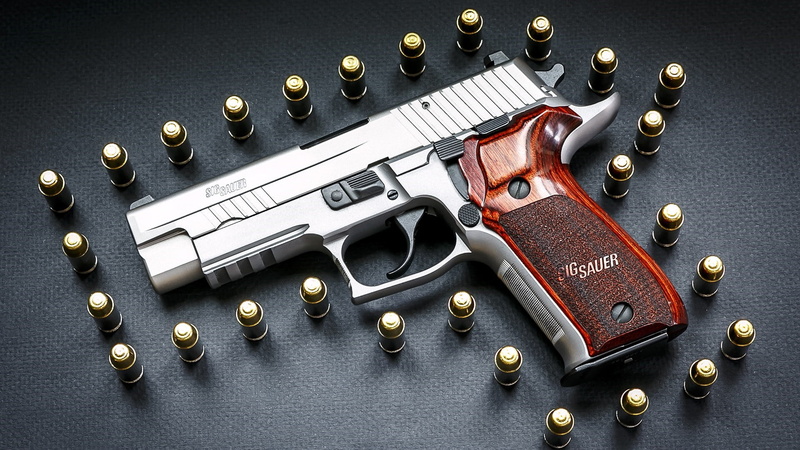 security, handgun, colored background, textile, gray background, studio shot, no people, indoors, gun, equipment, arts culture and entertainment, art and craft