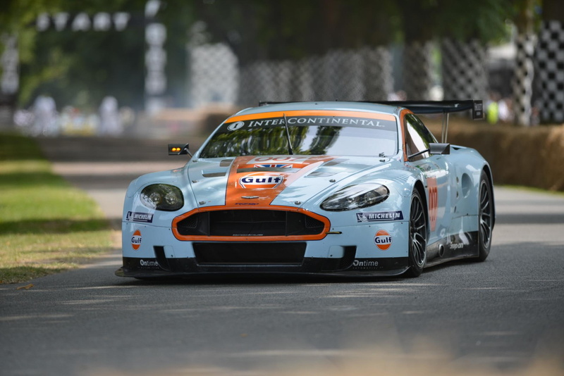 day, motor vehicle, city, selective focus, car, mode of transportation, aston, martin, no people, gulf, land vehicle, dbr, street, outdoors, focus on foreground