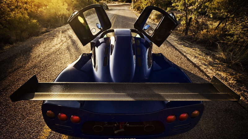 mode of transportation, mid-engine, machinery, day, Hypercar, metal, high angle view, Ultima GTR, agricultural equipment, Super Car , road, close-up, field