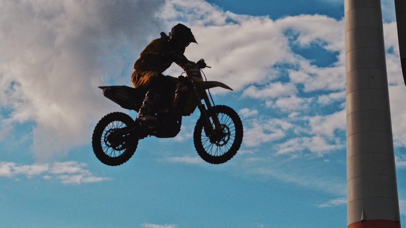 helmet, extreme sports, vehicle, motion, transportation, cloud - sky, person, stunt, daylight, competition, skill, man, low angle shot, speed, dom, road