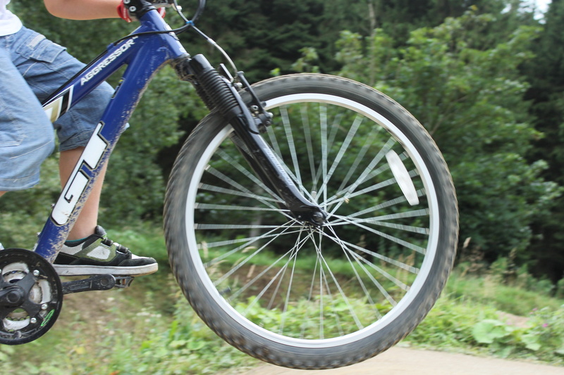 low section, sport, one person, human limb, nature, mode of transportation, child, plant, Mountain Biking, biking, outdoors, Leaping, Bicycle, action, leisure activity