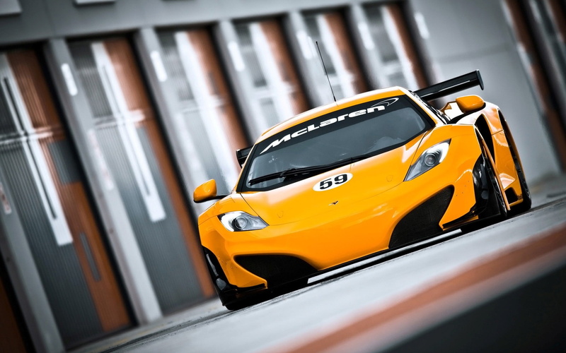car, mode of transportation, in a row, McLaren MP4-12C GT3, focus on foreground, yellow, day, public transportation, selective focus, outdoors, land vehicle