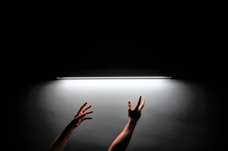 lighting equipment, human limb, hand, flooring, shelf, human body part, flare, spotlight, illuminated, person, body part, dungeon, light, human, indoors
