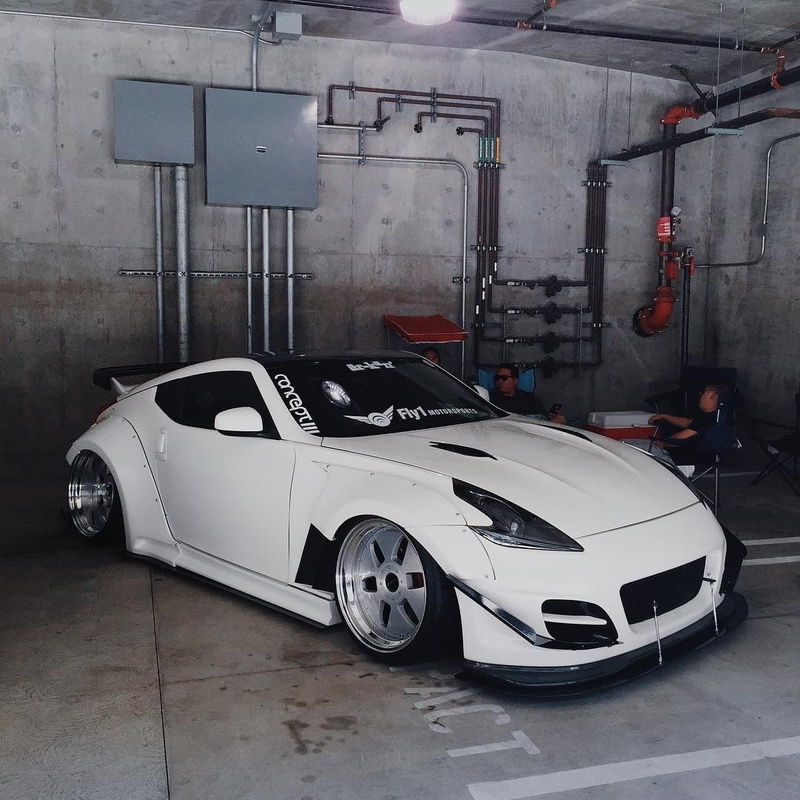 sports car, power supply, factory, white color, garage, 480P, built structure, shopping, no people, motor vehicle, land vehicle, metal, stationary, car