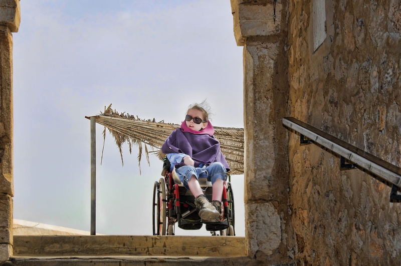 differing abilities, childhood, emotion, built structure, sitting, handicap, one person, architecture, outdoors, wheelchair, people, characters, day, woman