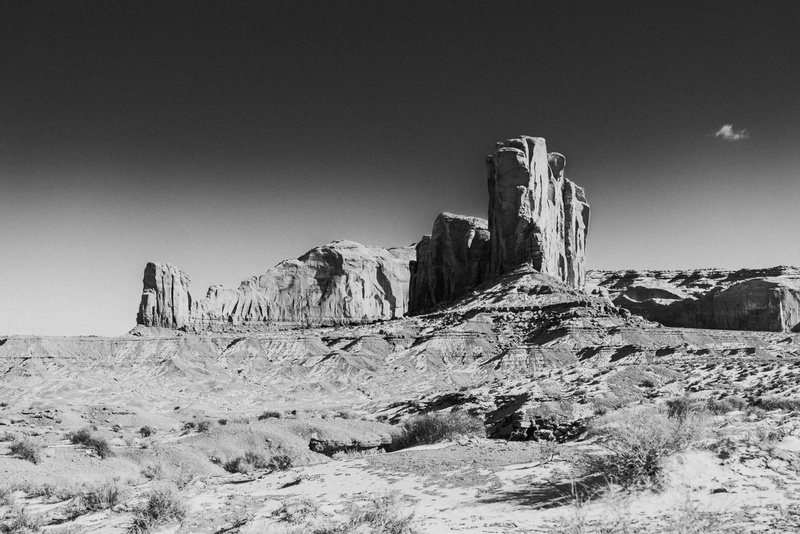 cliff, desert, rock - object, grayscale, scenics - nature, built structure, airplane, day, rock formation, monument valley, land, leisure activities, archaeology