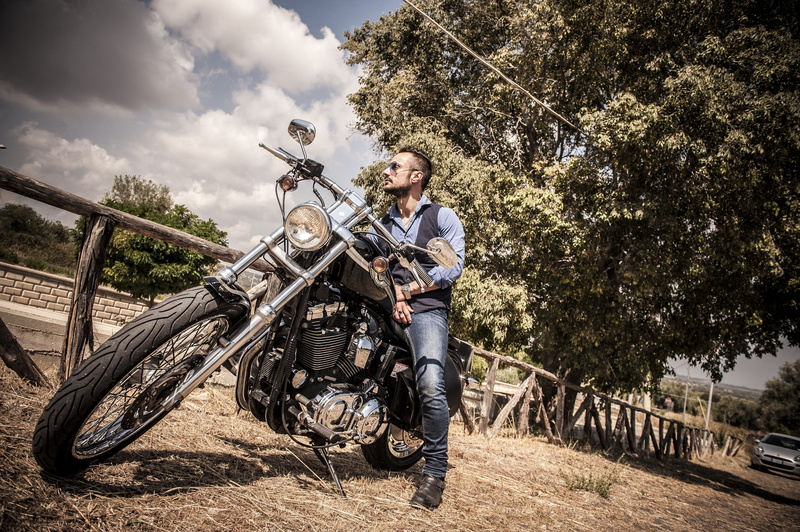 riding, dom, plant, one person, motorcycles, jeans, men, holding, outdoors, males, bicycle, tree, sportster, full length, harley davidson, beard, motorcycle