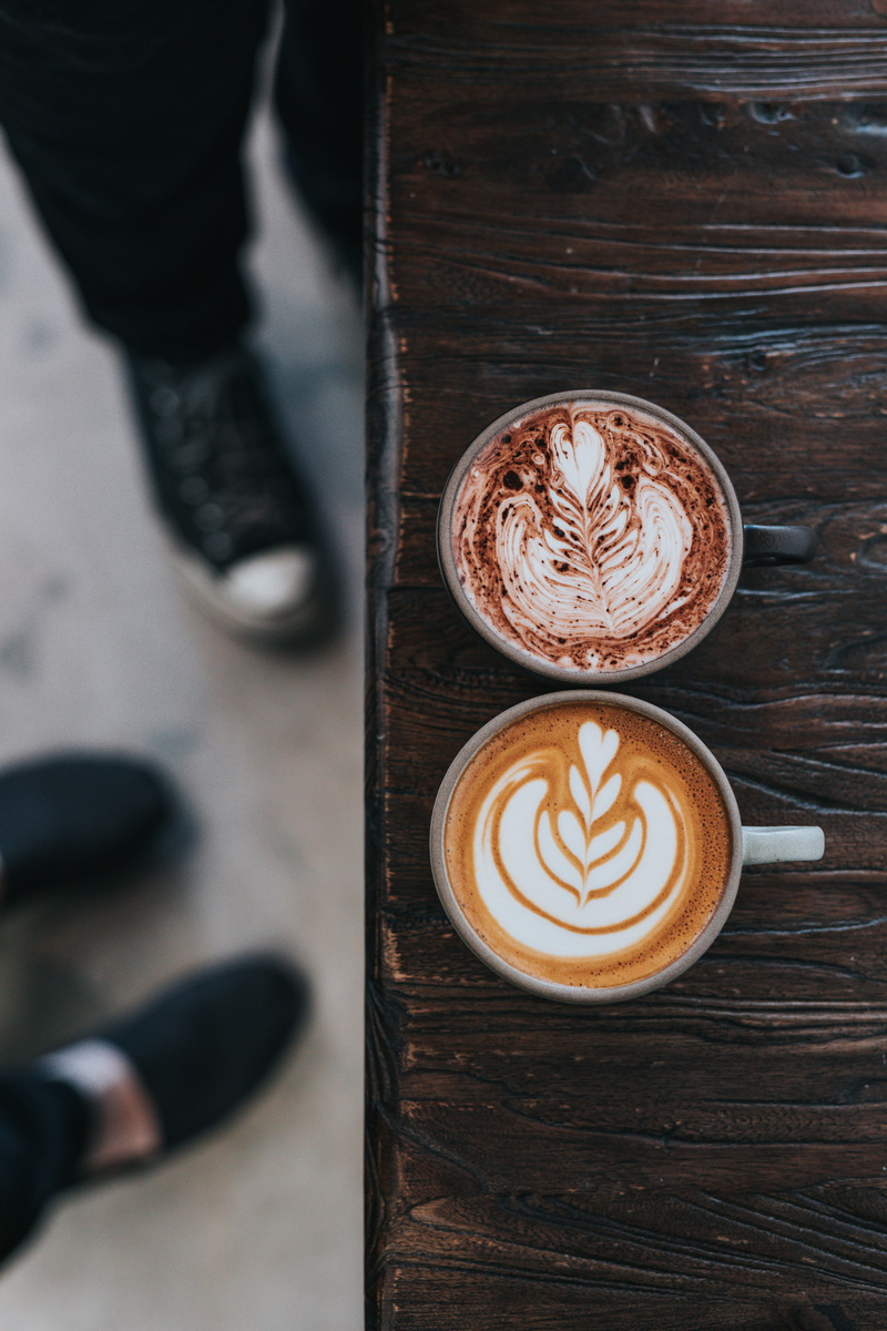 crockery, mug, frothy drink, table, cappuccino, photo, coffee lover, mugs, shallow, human foot, one person, shoe, low section, cup, body part, human body part