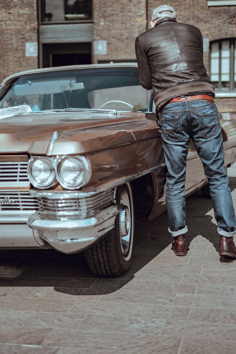 motor vehicle, mode of transportation, near, leisure activity, street, standing, old-fashioned, travel, adult, men, land vehicle, transportation, jacket